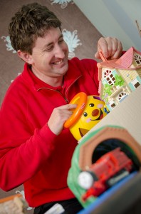 Professional removals man packing a child's toys